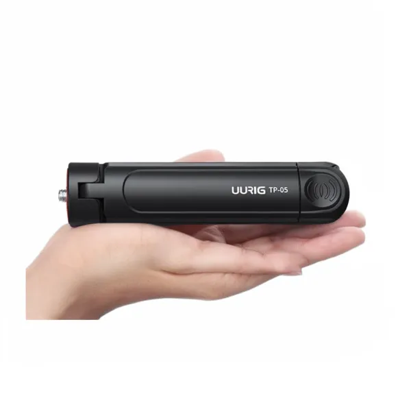 Mini trépied pliable EHANG tenu dans une main, support bureau pour smartphone et appareils légers